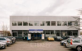Exterior view of office building at Anthony Fokkerweg 3, Amsterdam New-West, surrounded by a parking area. Ideal for office space rental.