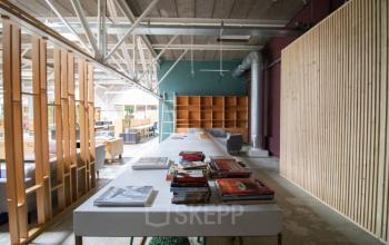 Modern office to rent with open floor plan at Anthony Fokkerweg 3, Amsterdam Nieuw-West. Spacious interior with stylish dividers, wooden accents, and ample natural light, enhancing a collaborative work environment.