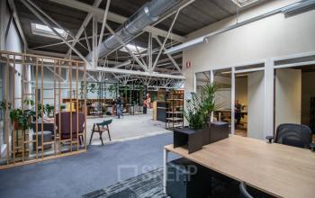 Spacious office to rent in Amsterdam New-West at Anthony Fokkerweg 3 featuring an open floor plan with modern furnishings, natural light, and an industrial design. Ideal for creative and collaborative work environments.