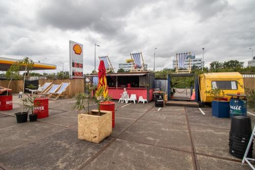 Outdoor area at Anthony Fokkerweg 3, in Amsterdam Nieuw-West, featuring colorful seating arrangements next to a shipping container, suitable for creative workspace solutions with potential for office space rental.