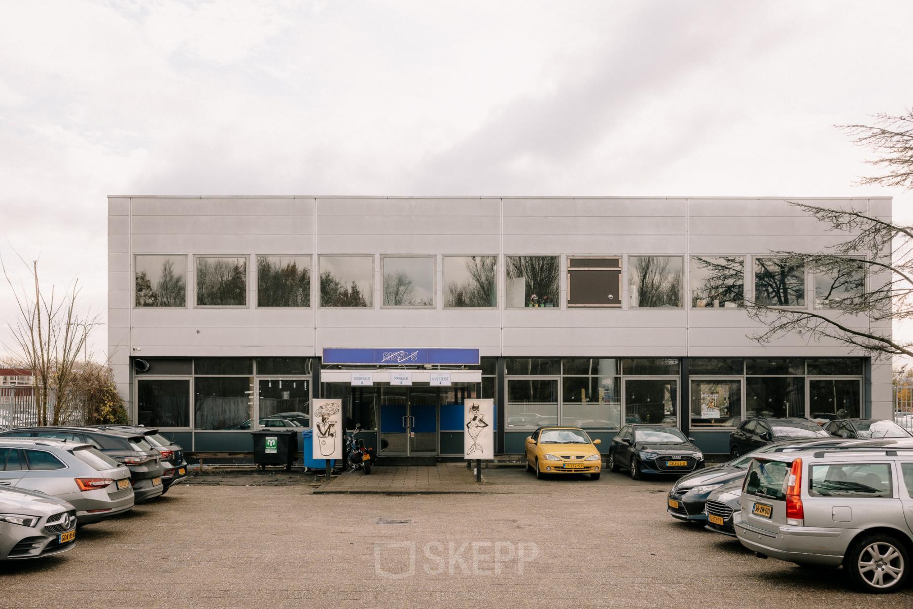 Exterior view of office building at Anthony Fokkerweg 3, Amsterdam New-West, surrounded by a parking area. Ideal for office space rental.