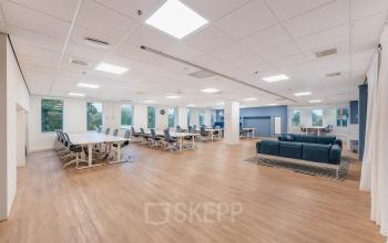 Spacious and bright office space at Koningin Wilhelminaplein 1 in Amsterdam New-West, featuring modern furnishings and ample natural light, perfect for an open floor plan setup. Ideal for companies seeking office space rental.