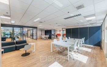 Bright office space at Koningin Wilhelminaplein 1, Amsterdam New-West, featuring modern workstations, natural lighting, and sleek furnishings. Ideal for those looking to rent office space in a vibrant setting.