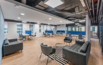 Spacious modern office in Amsterdam New-West with open seating, stylish furniture, and a contemporary design, perfect for professionals seeking office space rental.