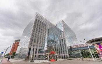 Modern glass exterior of office building at Koningin Wilhelminaplein 1 in Amsterdam New-West, ideal for office space rental.