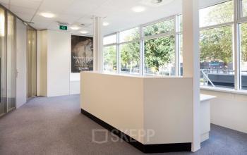 Bright and inviting office space at Baden Powellweg 283/305 with large windows and neutral decor, perfect for an efficient work environment in Amsterdam Nieuw-West.