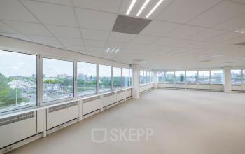 Bright and spacious office to rent at Overschiestraat 61, Amsterdam New-West, with large windows offering abundant natural light and cityscape views.