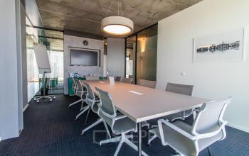 Furnished conference room for office space rental with a long table and chairs at Kraanspoor 12-58 in Amsterdam North.