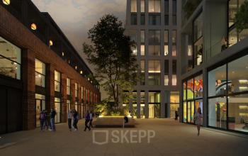 Evening view of the exterior at Papaverhof 58, Amsterdam North, featuring a modern office building with people socializing outside. Ideal for those looking to rent office space.