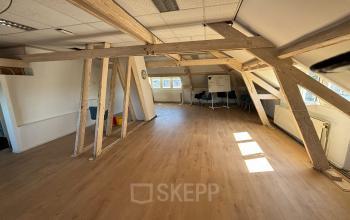 Open-floor office space rental with wooden beams and large windows at Hamerstraat 24, Amsterdam North, Amsterdam.