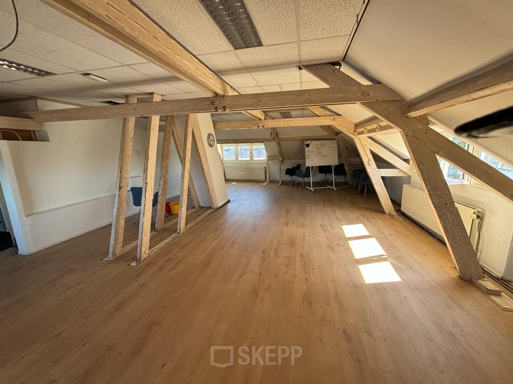 Open-floor office space rental with wooden beams and large windows at Hamerstraat 24, Amsterdam North, Amsterdam.