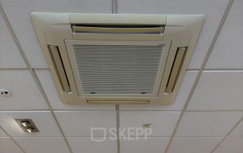 Ceiling view in an empty office space with tiled panels and ceiling air conditioning at Buikslotermeerplein 430, Amsterdam North.