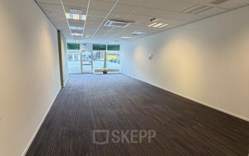 Spacious interior of an unfurnished office to rent at Buikslotermeerplein 430, Amsterdam North, with bright lighting and large windows at the far end.