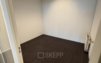 Unfurnished office space at Buikslotermeerplein 430, Amsterdam North available for rental, featuring modern lighting and dark flooring.