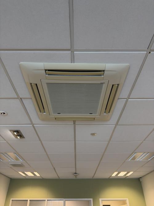 Ceiling view in an empty office space with tiled panels and ceiling air conditioning at Buikslotermeerplein 430, Amsterdam North.