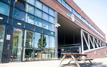 Modern office space rental at Asterweg 19, Servicepunt Kaap Noord, with a brick facade and large, welcoming windows.