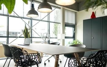 Contemporary office space rental at Asterweg 19 in Amsterdam North with a stylish meeting table, designer chairs, and ample natural light.