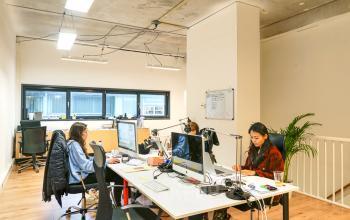 Modern, well-lit office space rental at Asterweg 19 in Amsterdam North, with professionals focused on their tasks amid contemporary furnishings.
