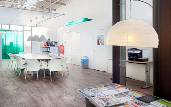Office space rental at Distelweg 78-80 in Amsterdam North featuring a bright workspace with modern furnishing, ample seating, and contemporary lighting.
