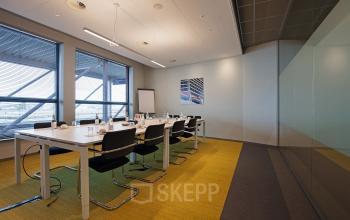 Modern conference room with long table and chairs at Piet Heinkade 55, Amsterdam East, ideal for office space rental.