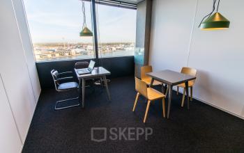 Bright office space for rent at Piet Heinkade 55, Amsterdam East, featuring modern furnishings and a stunning view, ideal for work and meetings.