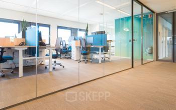 Modern office space rental at Science Park 301 in Amsterdam East, featuring an open floorplan with glass partitions and ergonomic chairs, creating a professional and collaborative workspace environment.