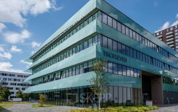 Exterior view of office building at Science Park 301, Amsterdam East, featuring modern glass architecture, available for office to rent.