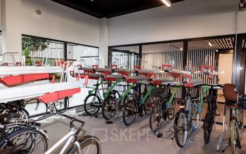 Bicycle storage area with multiple bike racks in the office building at Science Park 301, Amsterdam East. Ideal for businesses seeking office space rental with convenient cycling access.