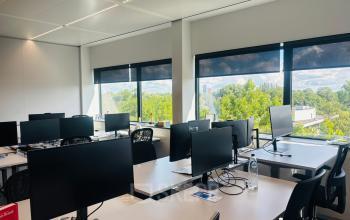 Bright, furnished office at Science Park 301 in Amsterdam East, featuring multiple desks with computer monitors and large windows providing natural light. Ideal for those seeking office space rental.