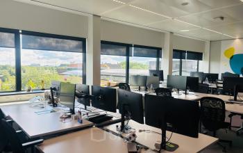 Bright office space for rent with multiple workstations, large windows, and views of Amsterdam East at Science Park 301.