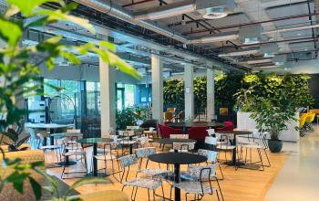 Modern office space at Science Park 301 in Amsterdam East featuring open workspaces with contemporary furniture, lush greenery, and natural lighting. Ideal for office space rental or finding an office to rent.