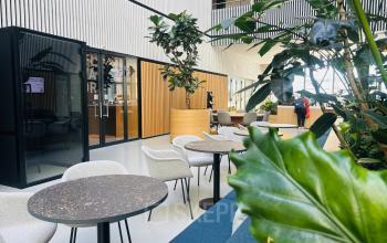Modern office space at Science Park 301 in Amsterdam East, featuring stylish furniture, greenery, and a glass booth, ideal for rent office space or office space rental.