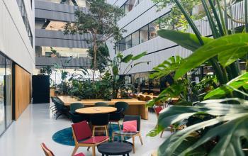 Modern office interior at Science Park 301, Amsterdam East, featuring lush greenery and stylish seating perfect for an inviting office space rental or office to rent.
