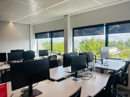 Bright, furnished office at Science Park 301 in Amsterdam East, featuring multiple desks with computer monitors and large windows providing natural light. Ideal for those seeking office space rental.