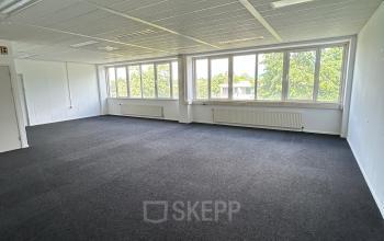 Spacious office to rent at James Wattstraat 71, Amsterdam East, featuring abundant natural light from large windows.