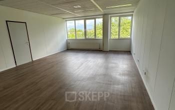 Spacious, unfurnished office at James Wattstraat 71, Amsterdam East, with large windows and ample natural light, ideal for office space rental.
