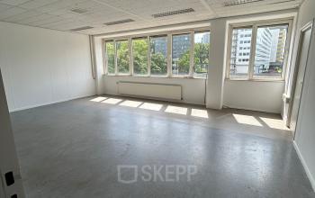Bright office space available for rent at James Wattstraat 71, Amsterdam East, featuring large windows and ample natural light.