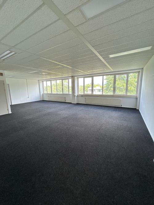 Spacious office to rent at James Wattstraat 71, Amsterdam East, featuring abundant natural light from large windows.