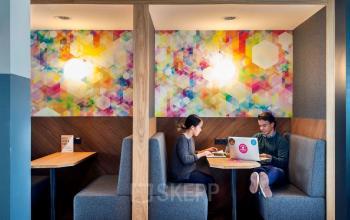 Office space rental at Weesperstraat 61 in Amsterdam East, Amsterdam, featuring cozy, furnished workspaces with modern decor and vibrant wall art.