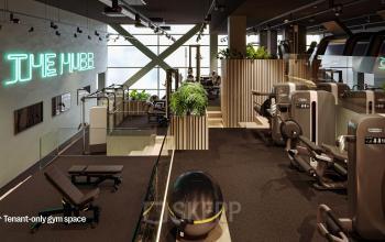 Modern gym space with various exercise equipment and neon sign, located in an office building at Jacob Bontiusplaats 9, Amsterdam East.