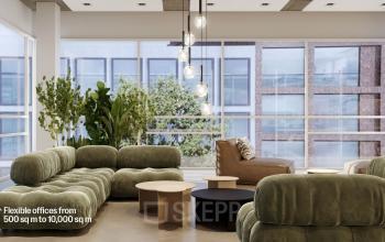 Modern office space rental at Jacob Bontiusplaats 9, Amsterdam Oost, featuring stylish green sofas and chic hanging lights.