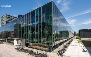Modern glass office building at Jacob Bontiusplaats 9, Amsterdam East, available for office space rental with a view of the canal.