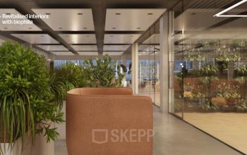 Modern office space at Jacob Bontiusplaats 9, Amsterdam East, featuring open floor plan with biophilic design elements and natural light, perfect for office space rental.
