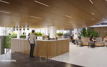 Modern office interior at Jacob Bontiusplaats 9, Amsterdam East, with a sleek reception desk, wooden ceiling, and people engaged in business discussions.