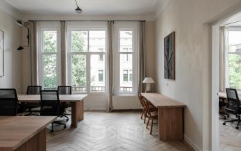 Bright office space rental at Jacob Obrechtstraat 56, Amsterdam Old South, featuring modern furnishings with large windows and natural lighting.