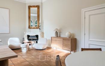 Bright office space with modern furniture and a fireplace, located at Emmalaan 7-9, ideal for office space rental in Amsterdam Old South.