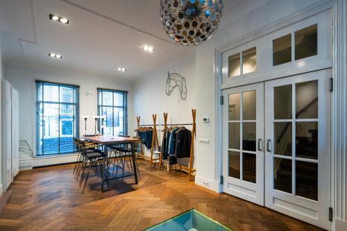 Bright office space to rent at PC Hooftstraat 150, Amsterdam Old South, featuring a stylish conference room with modern furniture and wooden flooring.