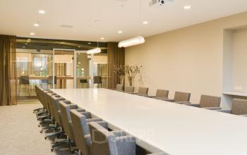 Modern conference room with a long table and multiple chairs, located at Olympisch Stadion 24-28, Amsterdam Old South, available for office space rental.