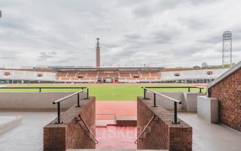 A view from the Olympisch Stadion in Amsterdam Old South, showcasing expansive seating and a wide field, ideal for various events.