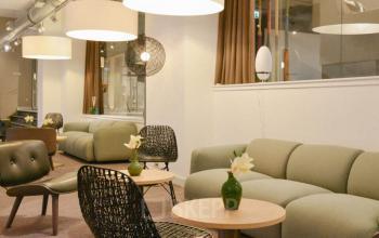 Lounge area with modern furniture, stylish lighting, and decor at the office space rental located at Olympisch Stadion 24-28, Amsterdam Old South.